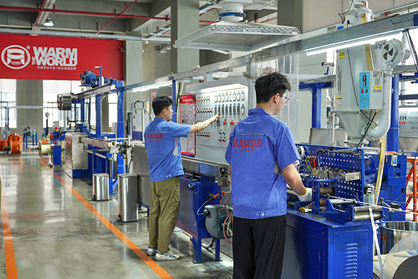 工人在操作電伴熱帶護套擠出設(shè)備 環(huán)瑞電熱供圖